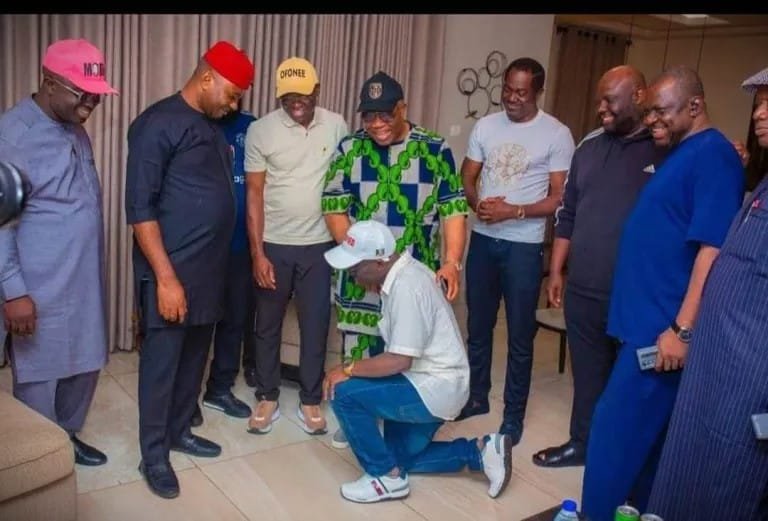 Edo State Governor Monday Okpebholo kneeling before Philip Shaibu and APC leaders