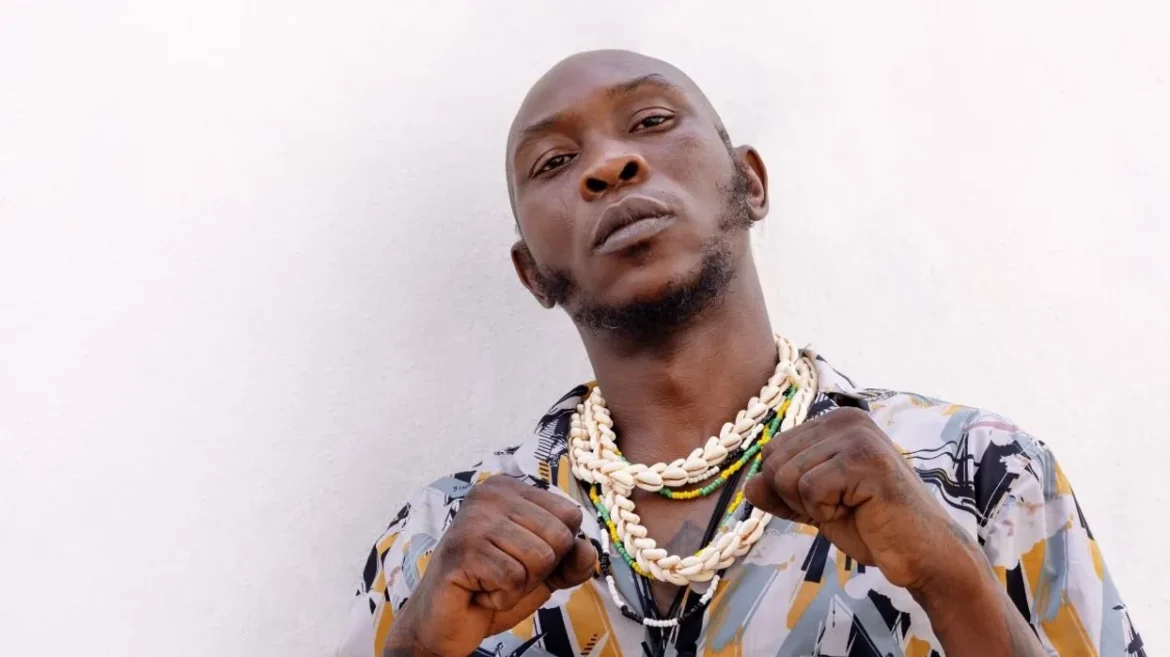 sean-kuti-holding-up-his-necklaces Seun Kuti